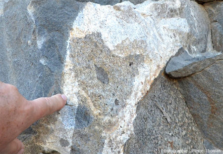 Vue rapprochée sur la masse de granite inter-gabbro, contenant une enclave de roche de teinte intermédiaire, contenant elle-même une enclave de gabbro